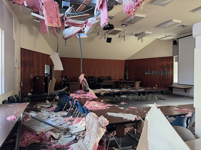 The District Office board room with the roof falling in and debris all over the ground.