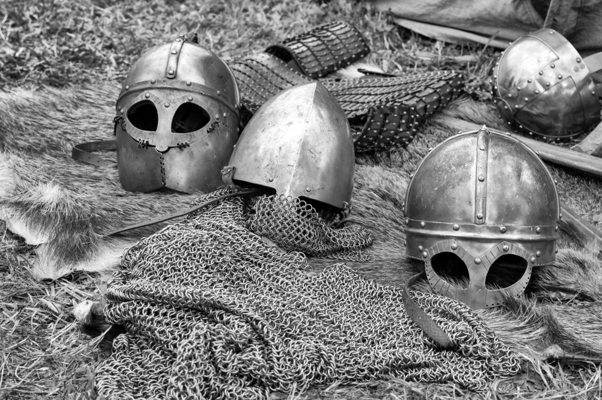 Helmets and chainmail lie on the ground