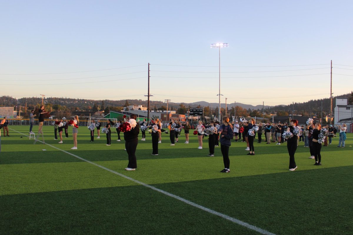 Band, cheer, color guard, and dance team all practicing together in preparation for the homecoming football game. 