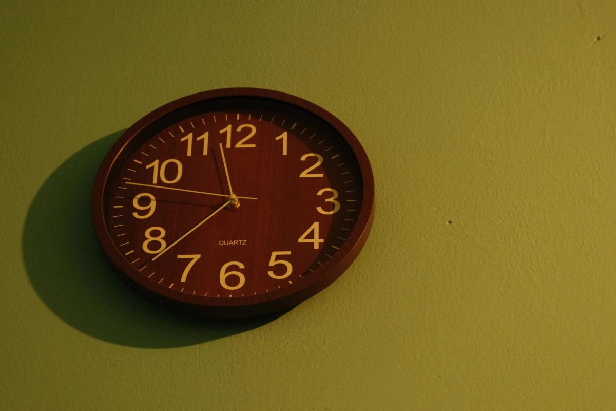 Red Wall Clock on Green Backdrop